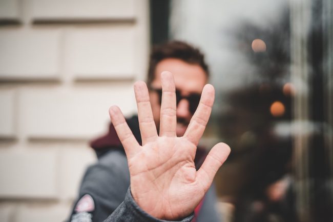 5 fingers man holding up 5 fingers