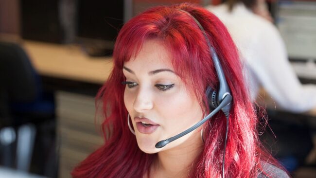 Red haired customer service agent with headset